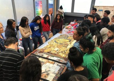 Students gathered around three works, "Under My Skin", Masada - Crystal Ball of History" and "Jasmine Red" — in Los Angeles, California.