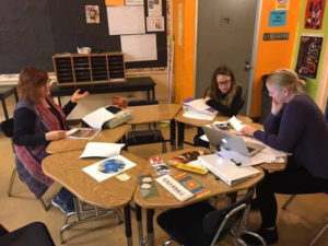 Maija Beeton (left) conferring with Carrie Hoff (right) and her teaching assistant, Emma (center).